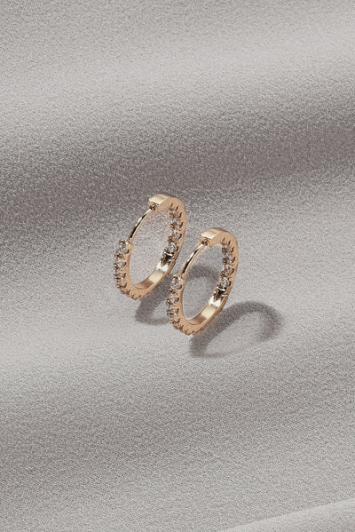 A basic shot of gold, mini hoop earrings with gem details and a regular clasp.