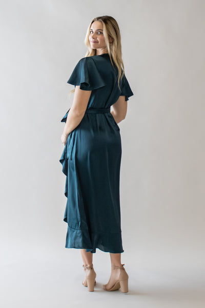 This is the back of a modest dress with flutter sleeves and ruffle details.