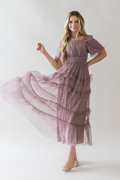 This is a modest dress with ruffle tulle details and a beautiful dusty lavender color.