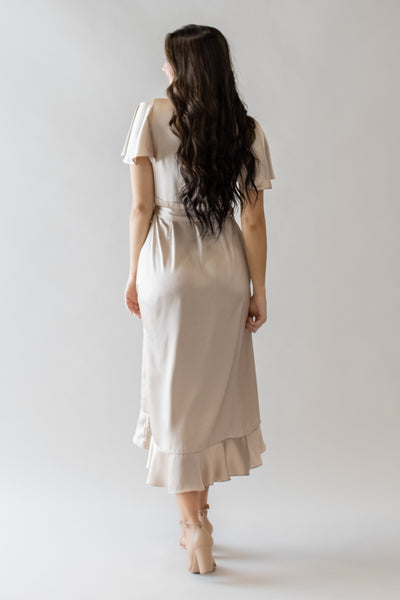 This modest dress features a beautiful champagne color and ruffle details.