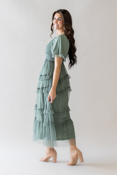 This is modest dress with ruffle details and a dusty green color.