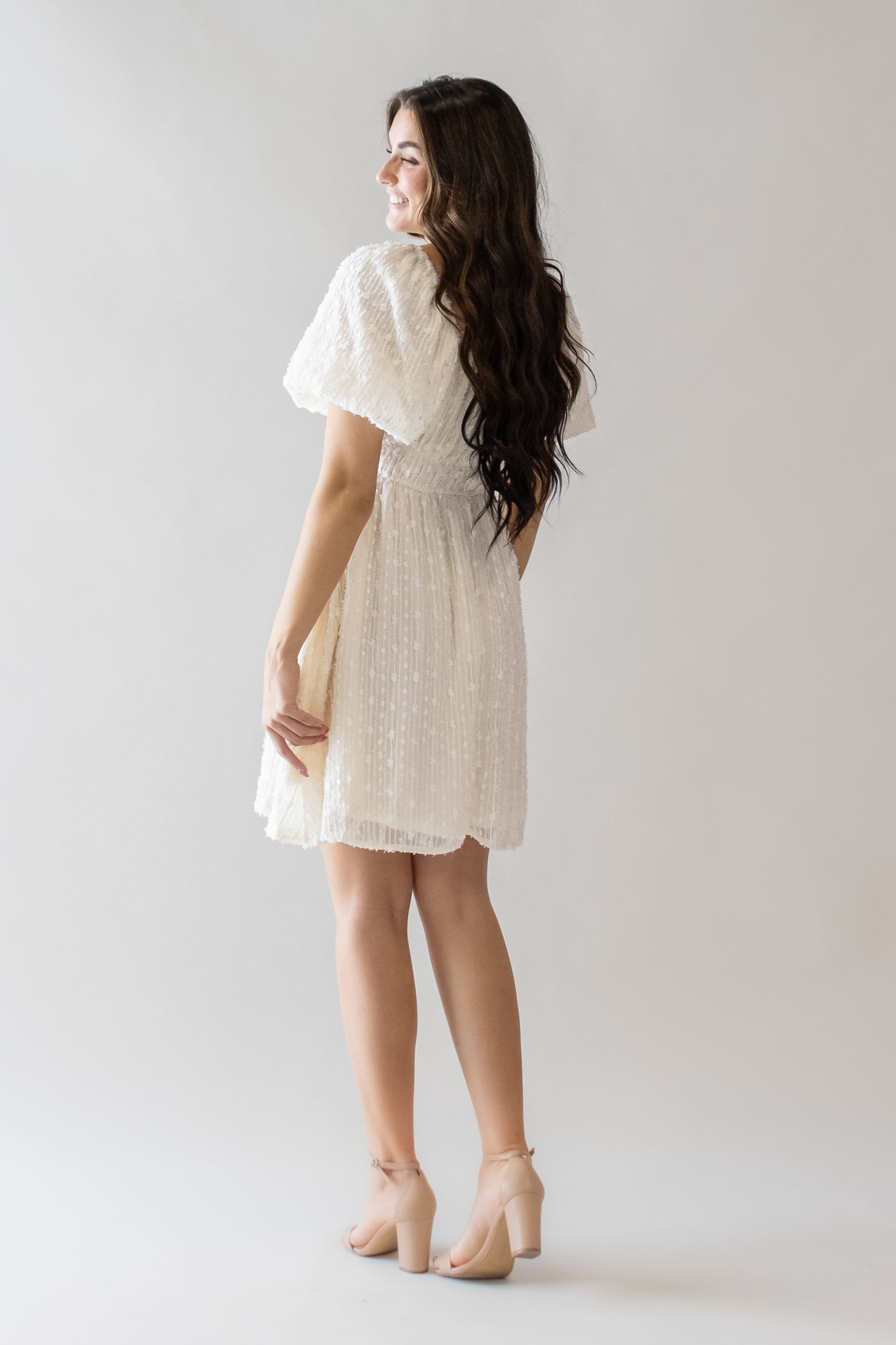 This modest dress features a puff sleeve and cream color perfect for a getaway dress
