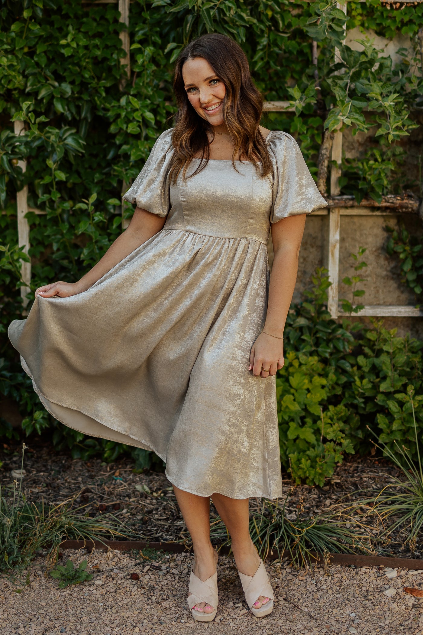 A front shot of our modest dress featuring a square neckline, puff sleeves, and a midi length skirt.