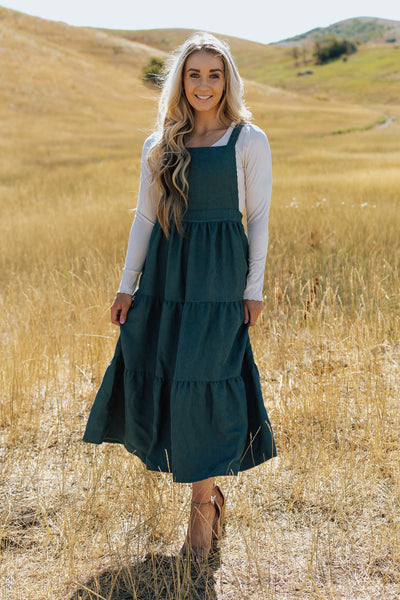 A front shot of a modest dress with corduroy fabric and an overall design.