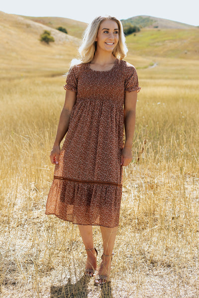 An additional front shot of a modest dress with a scoop neckline, smocked bodice and a fun floral pattern.