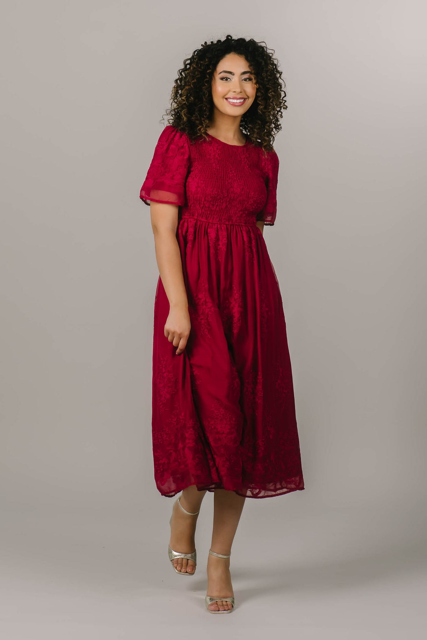 This beautiful modest bridesmaid dress features embroidered flowers and a fun magenta color.