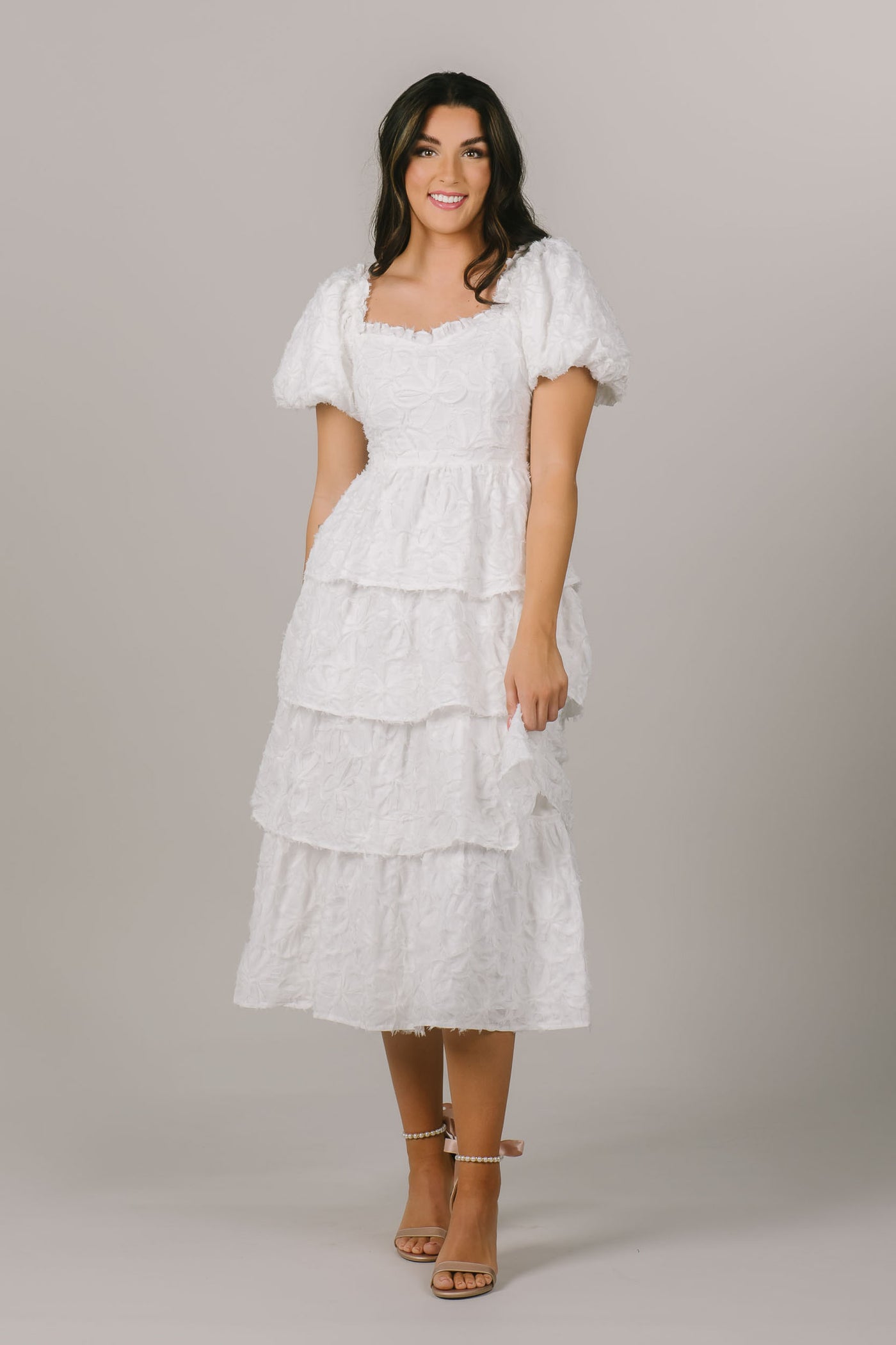 This modest getaway dress features lacy white details and a fun ruffled skirt.