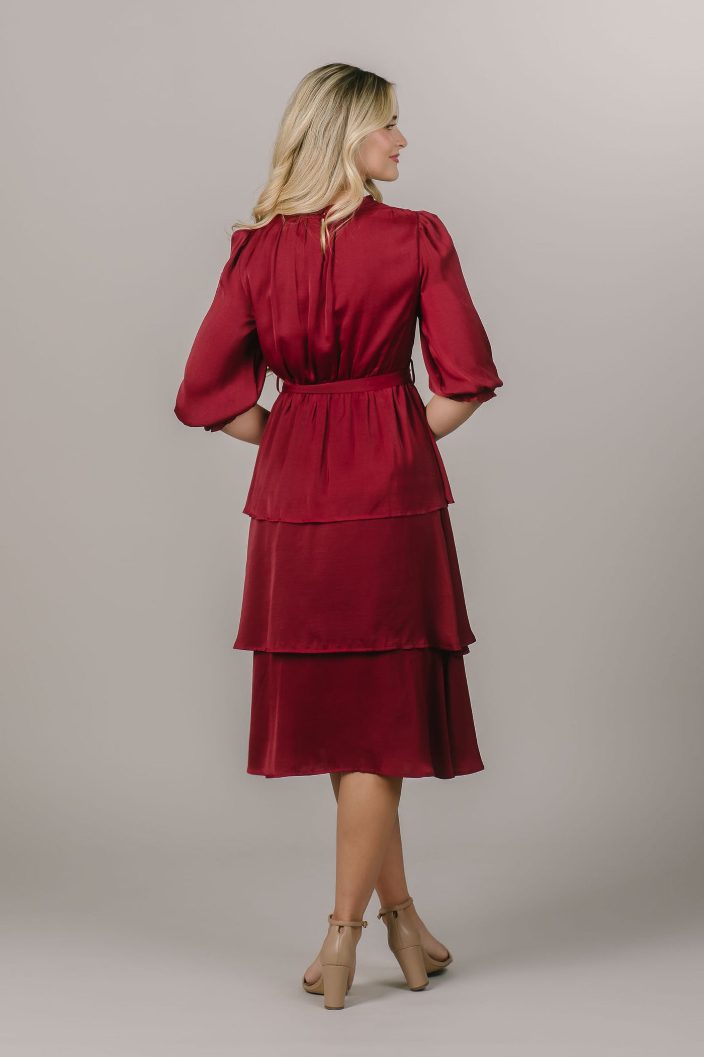 This is a modest dress with a tiered skirt and a silky smooth fabric.