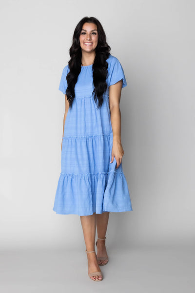 This is a modest dress with tiered details and a bright blue color.
