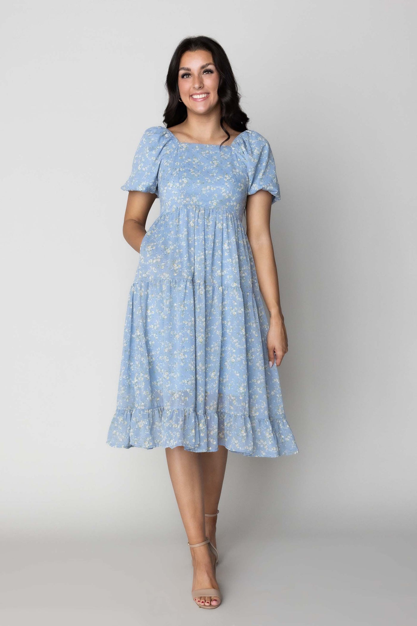 This is a modest dress with floral details and a fun bright blue color.