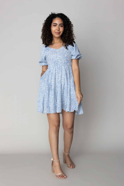This modest dress features a blue floral pattern and a small puff sleeve.