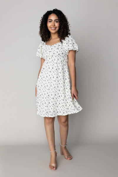 This is a modest dress with floral details and a sweetheart neckline.