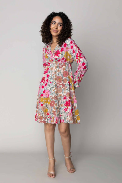 This is a modest dress with bright pink colors and bold paterns.
