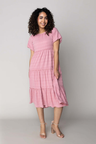 This modest dress features a fun textured fabric and a dusty pink.