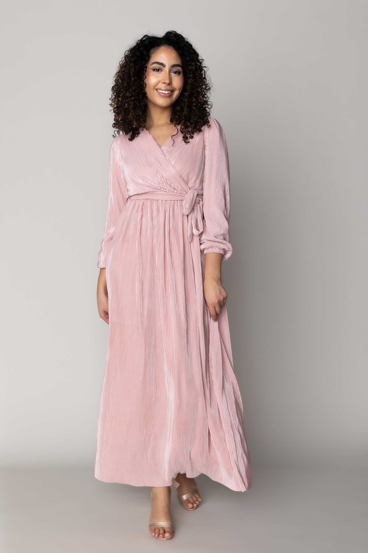 This is a modest dress with ribbed details and a tie around the waist.