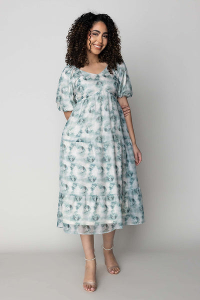 This is a modest dress with a sweetheart neckline and shear green details.