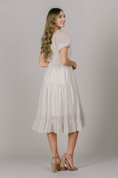 Back of modest dress in Utah with a flattering square neckline, cute tiers, and a fun and flirty midi length.