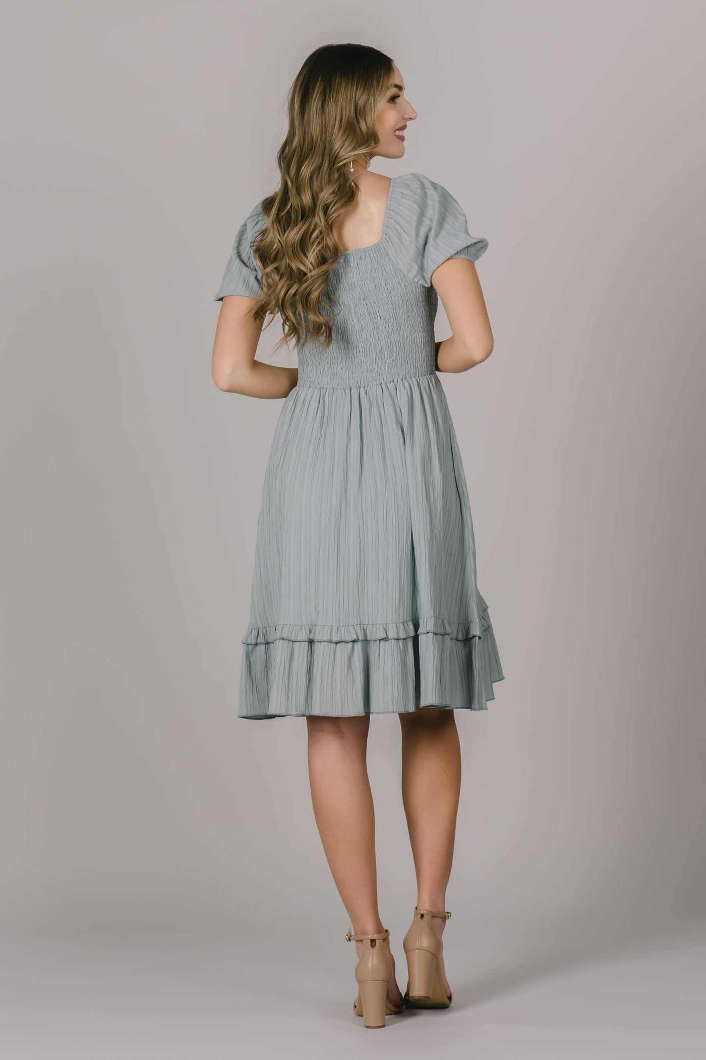 Back of modest dress in Utah with a soft square neckline, smocking across the back, and cute textured fabric throughout.