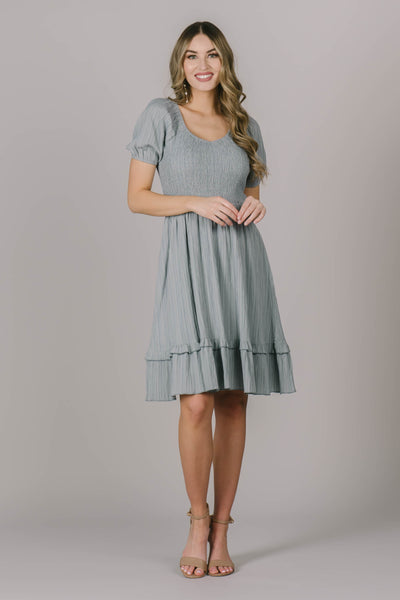 Modest dress in Utah with cute puff sleeves, a textured skirt below the smocking across the chest, and a cute scoop neckline.