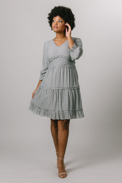 A long sleeve tiered dress with a v-neck in flint grey. Modest Dresses - Modest Clothing - Everyday Modest Dresses - Bridesmaid Modest Dresses. 