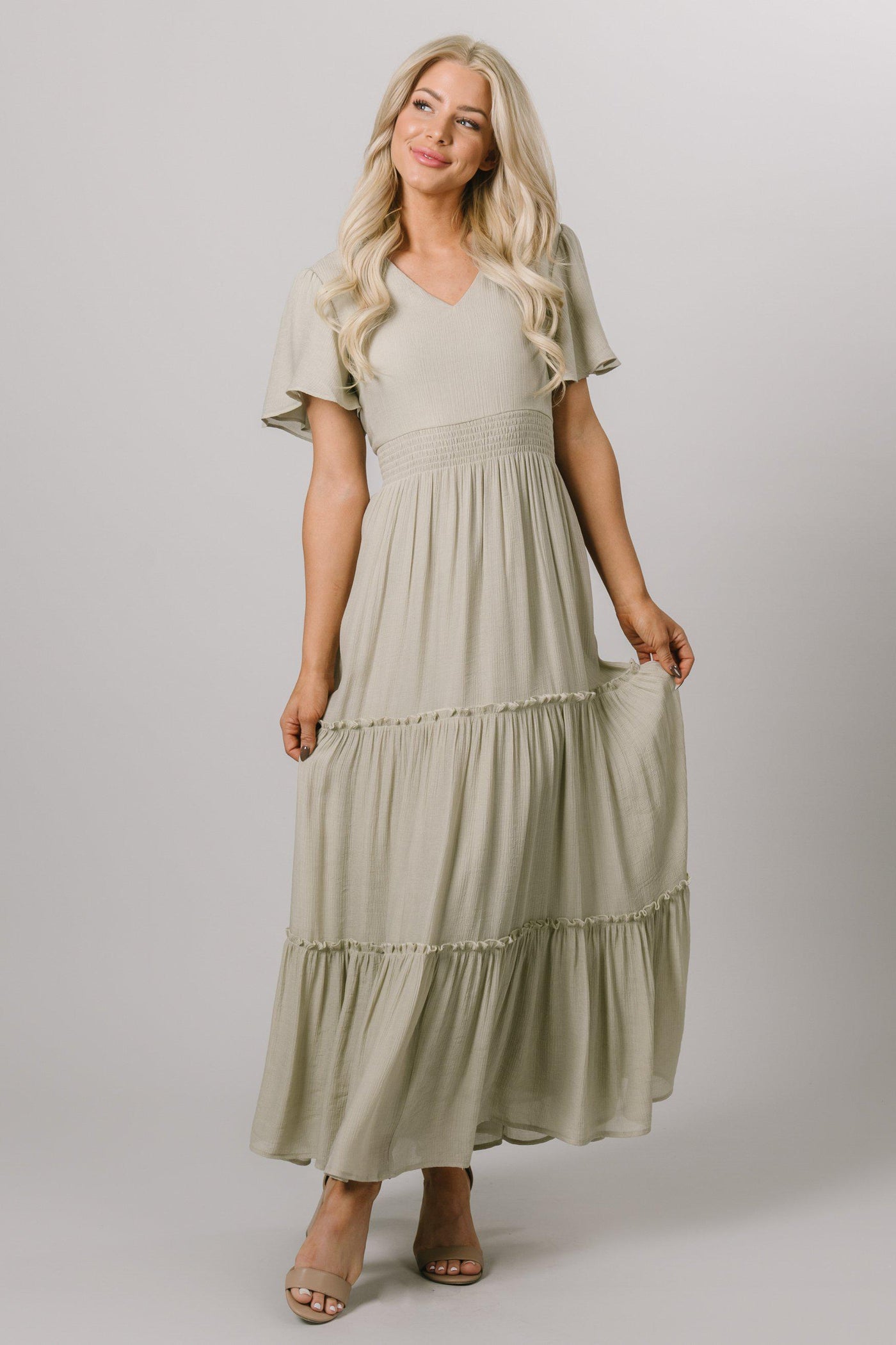 Modest Dresses - Modest Clothing - Everyday Modest Dresses - Bridesmaid Modest Dresses.  The model is wearing a size small. This ankle length dress featues a v-neckline, long flutter sleeves with a flowy bottom. 