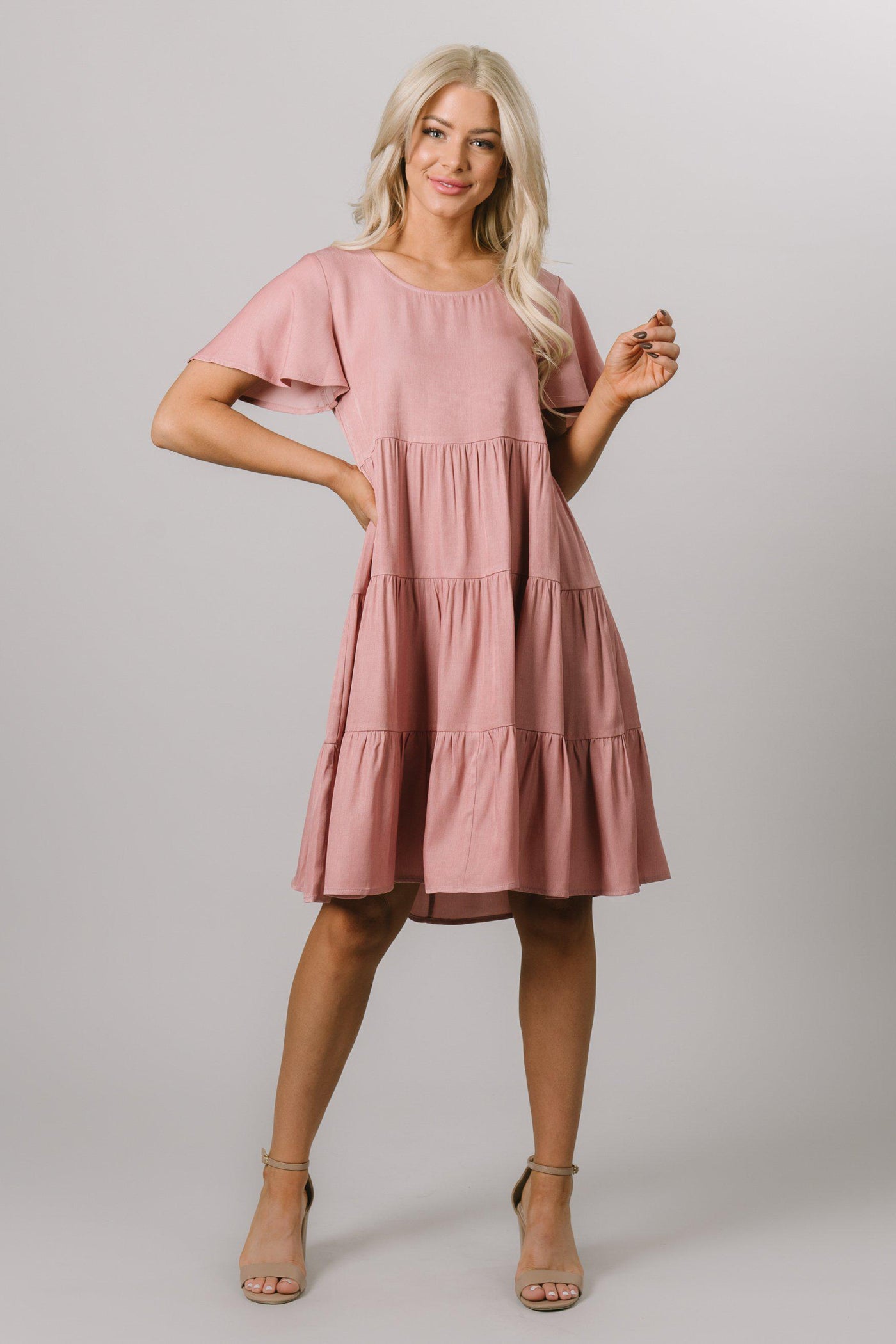 Modest Dresses - Modest Clothing - Everyday Modest Dresses - Bridesmaid Modest Dresses This Dusty Pink swing knee length dress has tiers and a scoop neck with flutter sleeves.