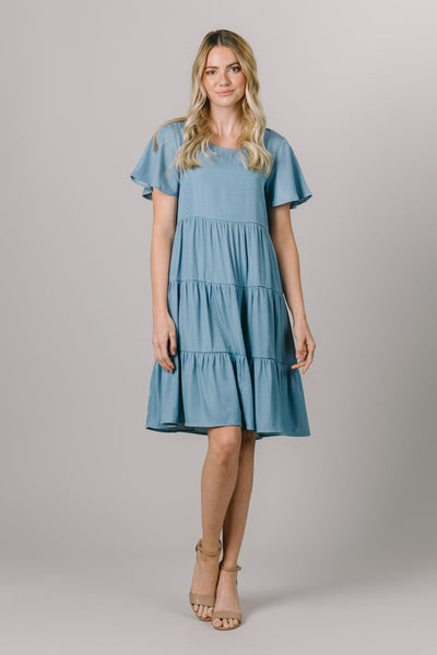 At Moments Made, we're obsessed with this tiered modest dress that features flutter sleeves and a round neckline. - Modest Clothing - Modest Dresses - Modest Everyday Dresses