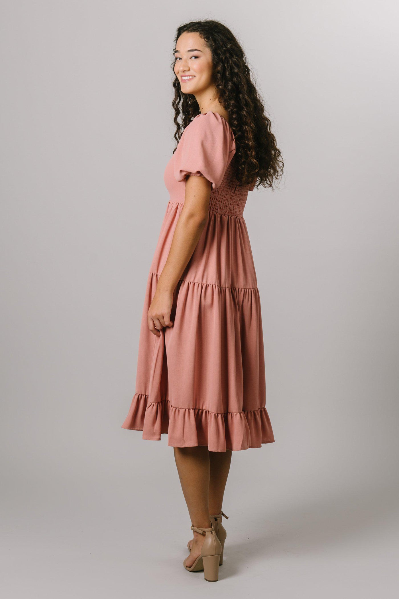 Our modest, smocked, tiered midi dress with a square neckline and 3/4 length puff sleeves in canyon rose. Modest Dresses - Everyday Modest Dresses - Bridesmaid Modest Dresses. 