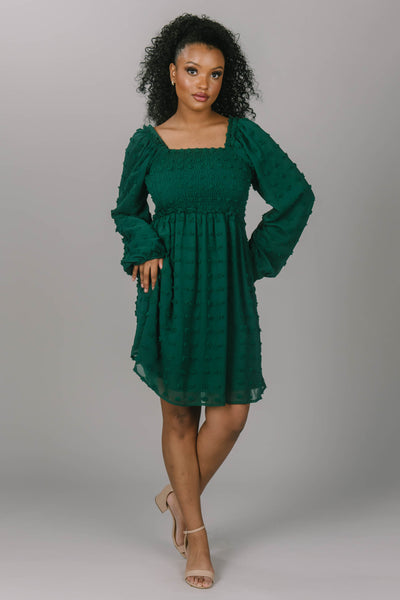 Front view of modest bridesmaid dress with Swiss dots with square neckline. It is a deep emerald color and super soft. Beautiful modest dress. 
