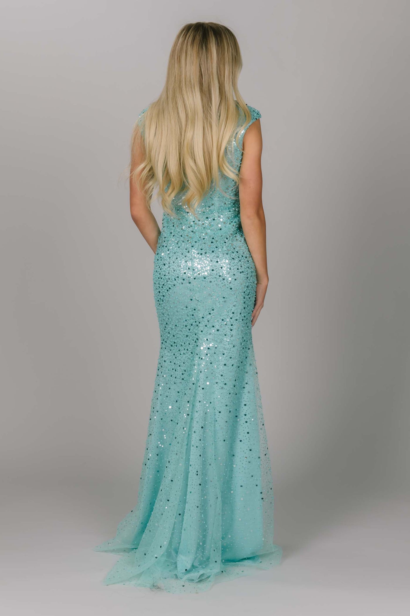 Blue sparkly modest prom dress. This dress has cap sleeves and is a fitted modest dress. This light blue dress is our new favorite modest prom dress.