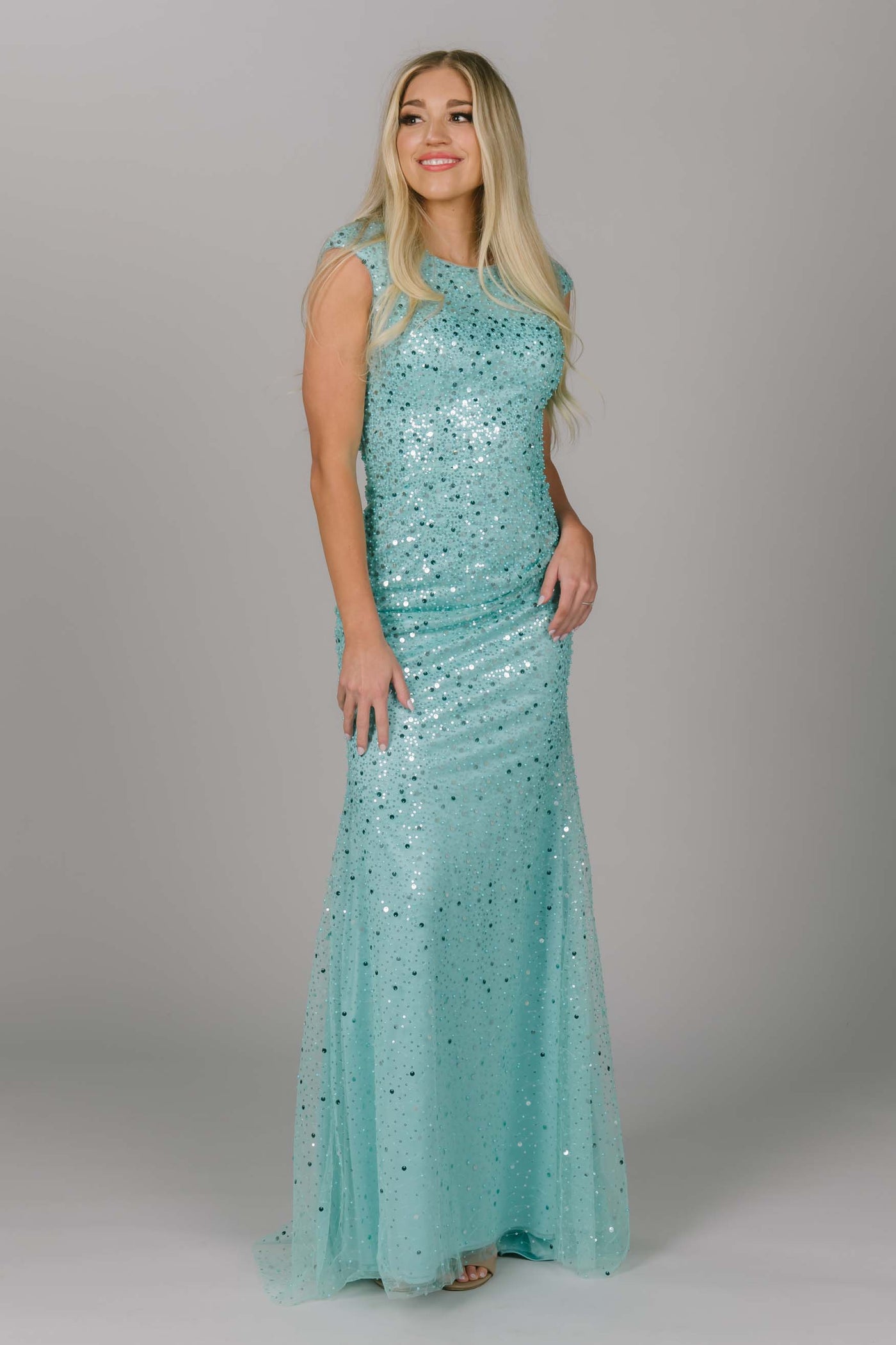 Blue sparkly modest prom dress. This dress has cap sleeves and is a fitted modest dress. This light blue dress is our new favorite modest prom dress. 