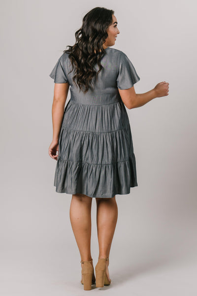 This plus size modest bridesmaids dress has a scoop neck, short sleeves and multiple tiers that are flattering on every figure. Shown in Pine. From Moments Made in Salt Lake City. Modest Dresses - Modest Clothing - Everyday Modest Dresses - Bridesmaid Modest Dresses