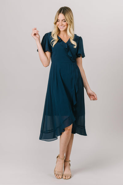 This fun modest dress is perfect for your everyday moments! It features a flattering fit and ruffles following the wrap all the way down to the hem! The sleeves also add a touch of fun! Available in Navy (pictured) and Burgundy. Modest Dresses - Modest Clothing - Everyday Modest Dresses - Bridesmaid Modest Dresses. 