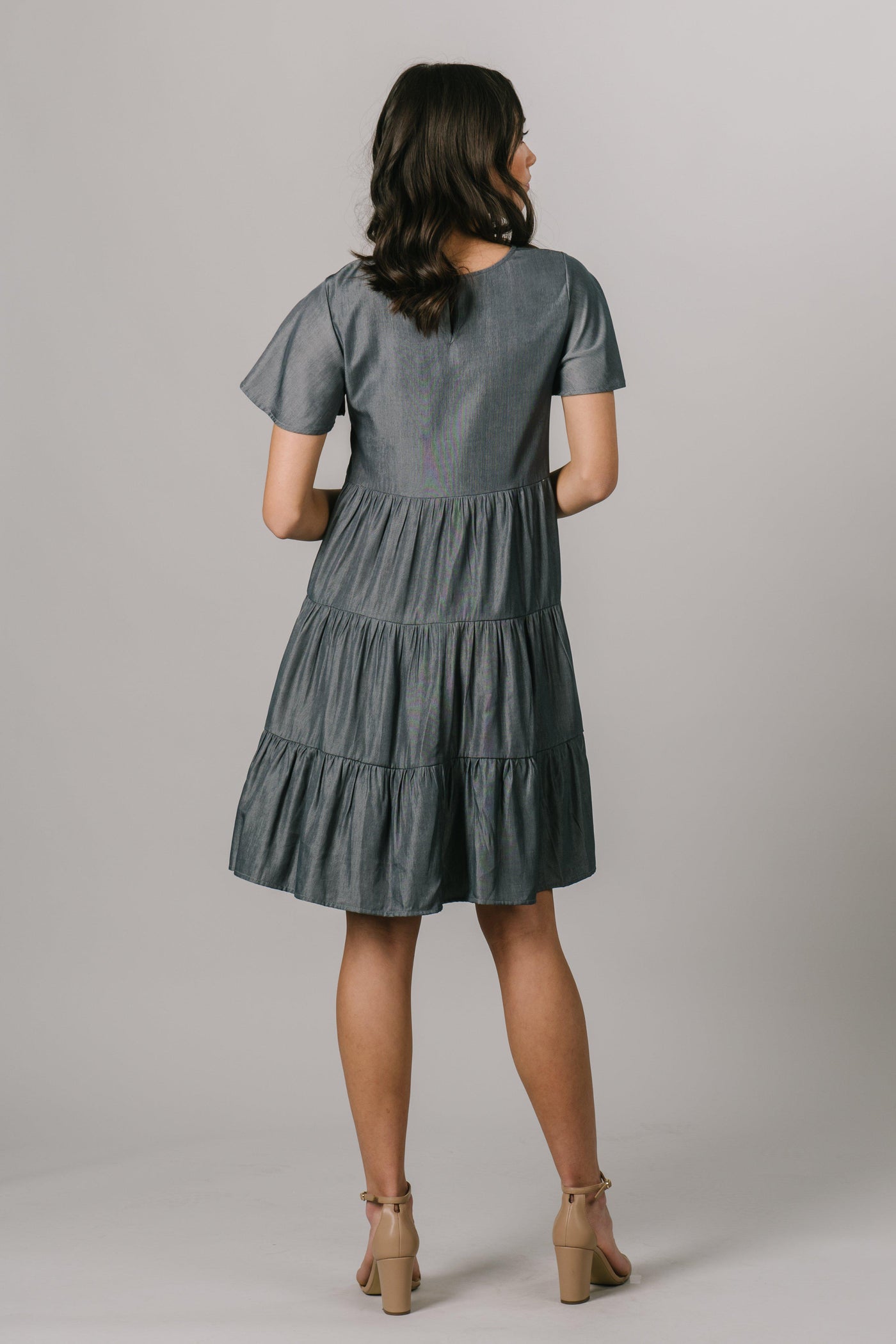 This modest bridesmaids dress has a scoop neck, short sleeves and multiple tiers that are flattering on every figure. Shown in Pine. From a dress shop called Moments Made. Modest Dresses - Modest Clothing - Everyday Modest Dresses - Bridesmaid Modest Dresses