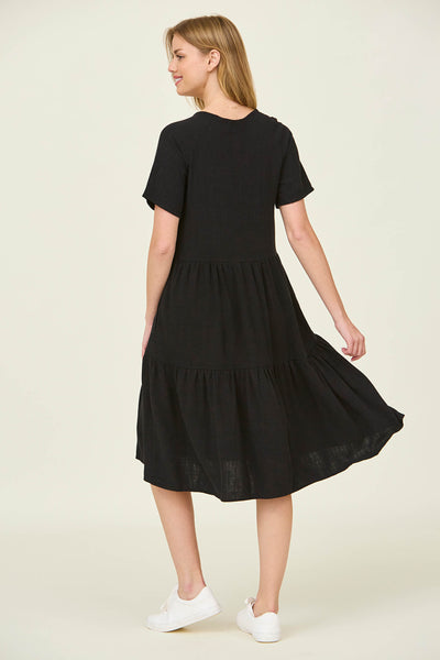 The back view of a tiered black dress with flutter sleeves at a modest dress shop in Bluffdale.