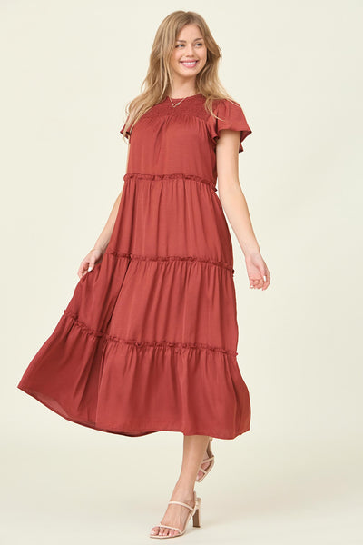 The front view of a tea length dress that is tiered with flutter sleeves in the color chocolate at a modest dress shop in Bluffdale.