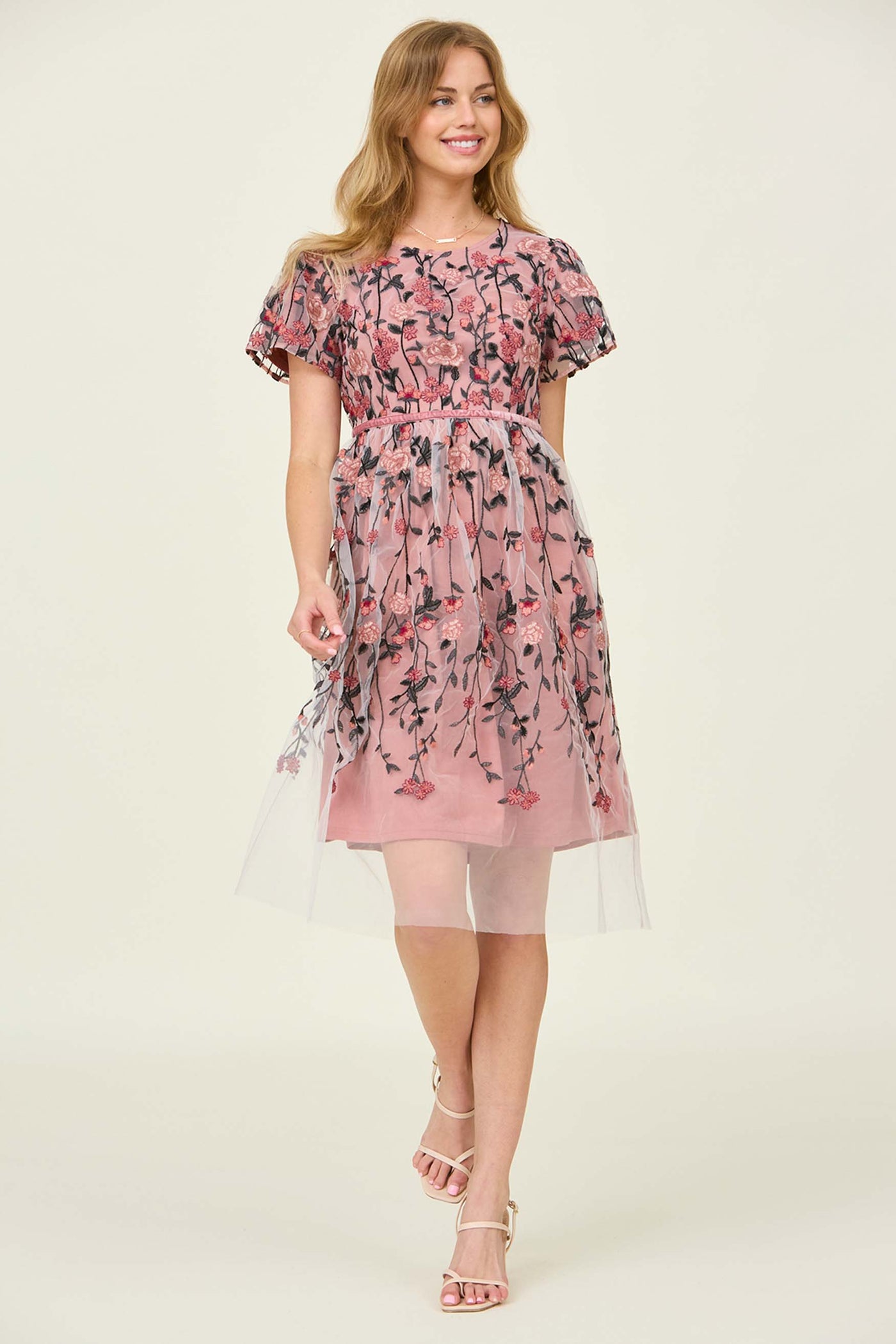 The front view of a pink floral dress wit a flutter sleeve at a modest dress shop in Bluffdale.