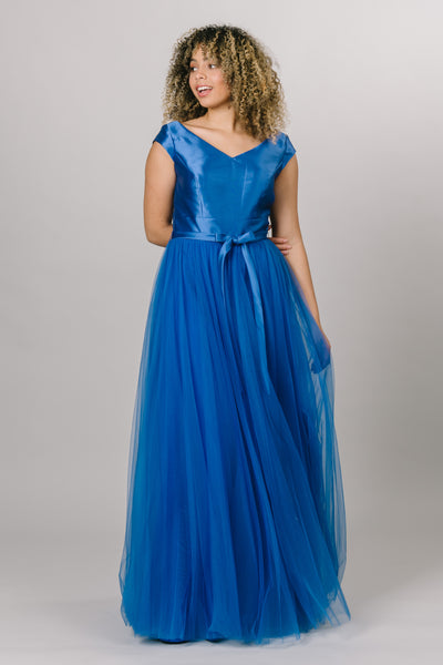 Modest Dresses - Modest Prom Dress - Formalwear Modest Dresses - Bridesmaid Modest Dresses. Dress in blue with v neckline and short sleeves and tulle skirt with bow as a belt. 
