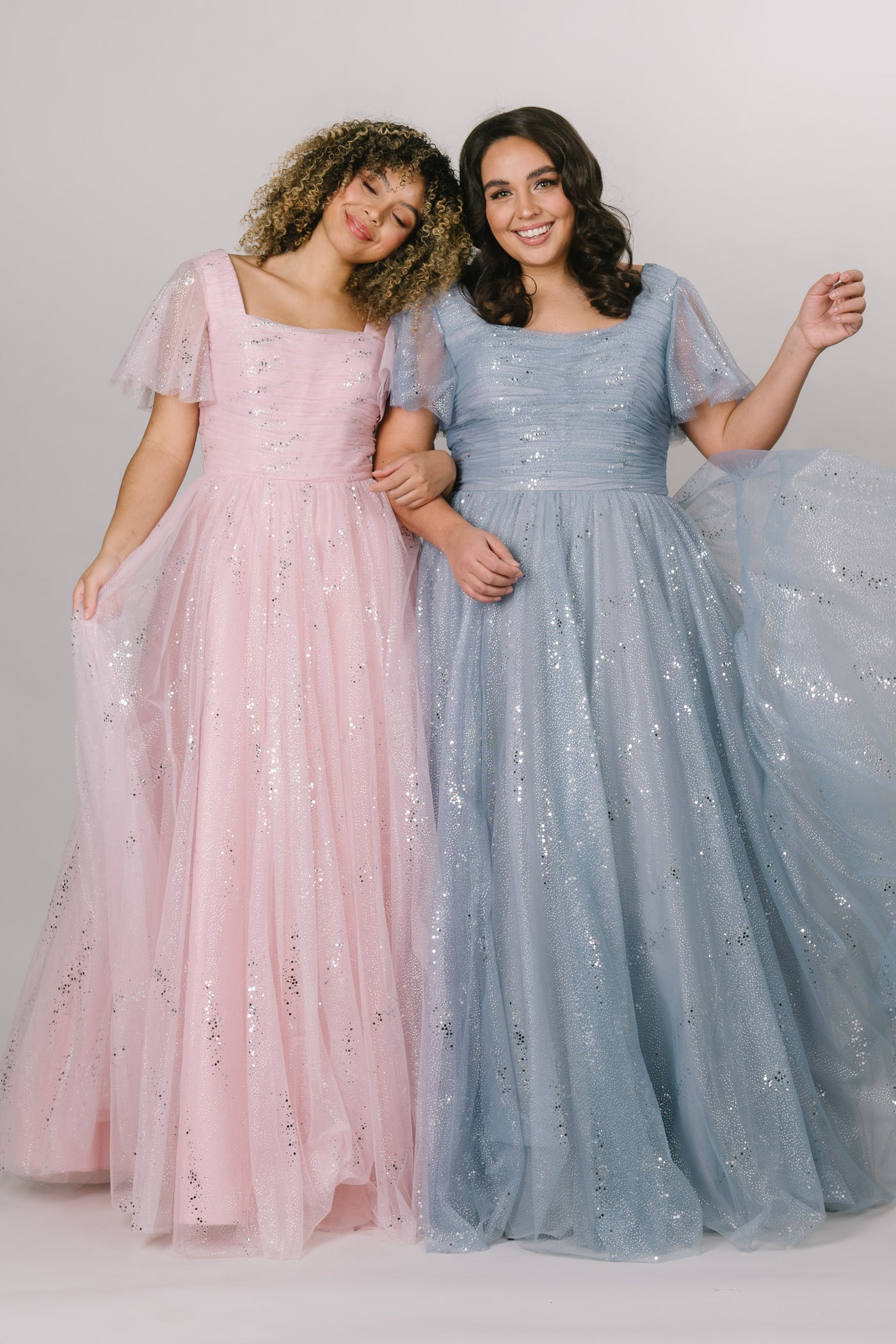Modest Dresses - Modest Prom Dress - Formalwear Modest Dresses - Bridesmaid Modest Dresses. Two ballgown dresses side by side in Pink and blue.