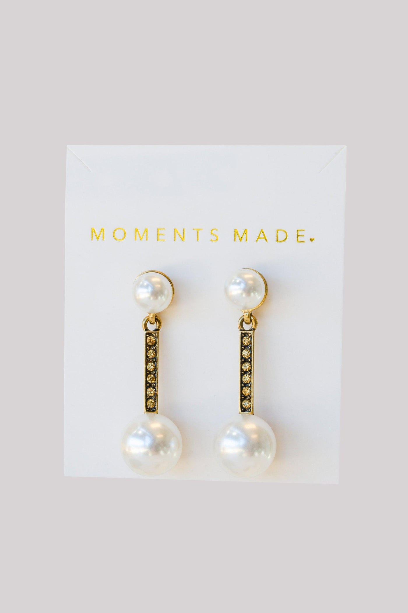 Pearl studded earrings, lined with gold dangling another larger pearl from bridal shop in salt lake city utah