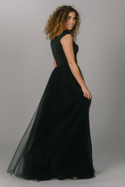 Black modest prom dress with tulle skirt. This a-line dress has cap sleeves and a square neckline. Beautiful modest prom dress.