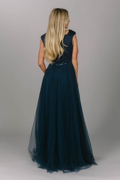 Navy modest prom dress with tulle skirt. This a-line dress has cap sleeves and a square neckline. Beautiful modest prom dress.