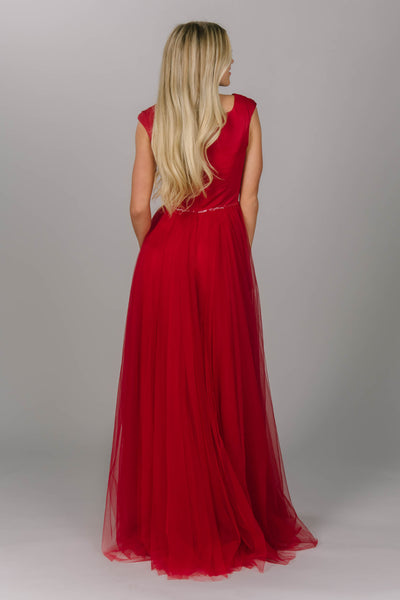 Red modest prom dress with tulle skirt. This a-line dress has cap sleeves and a square neckline. Beautiful modest prom dress.