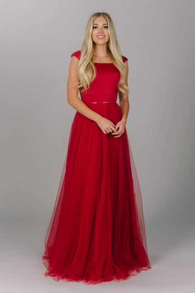 Red modest prom dress with tulle skirt. This a-line dress has cap sleeves and a square neckline. Beautiful modest prom dress.