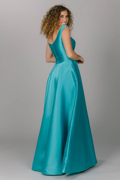 Blue modest prom dress that has a scoop neckline and a-line skirt. It has pockets and is perfect for the modest prom girl.