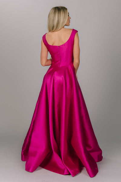 Pink modest prom dress that has a scoop neckline and a-line skirt. It has pockets and is perfect for the modest prom girl.