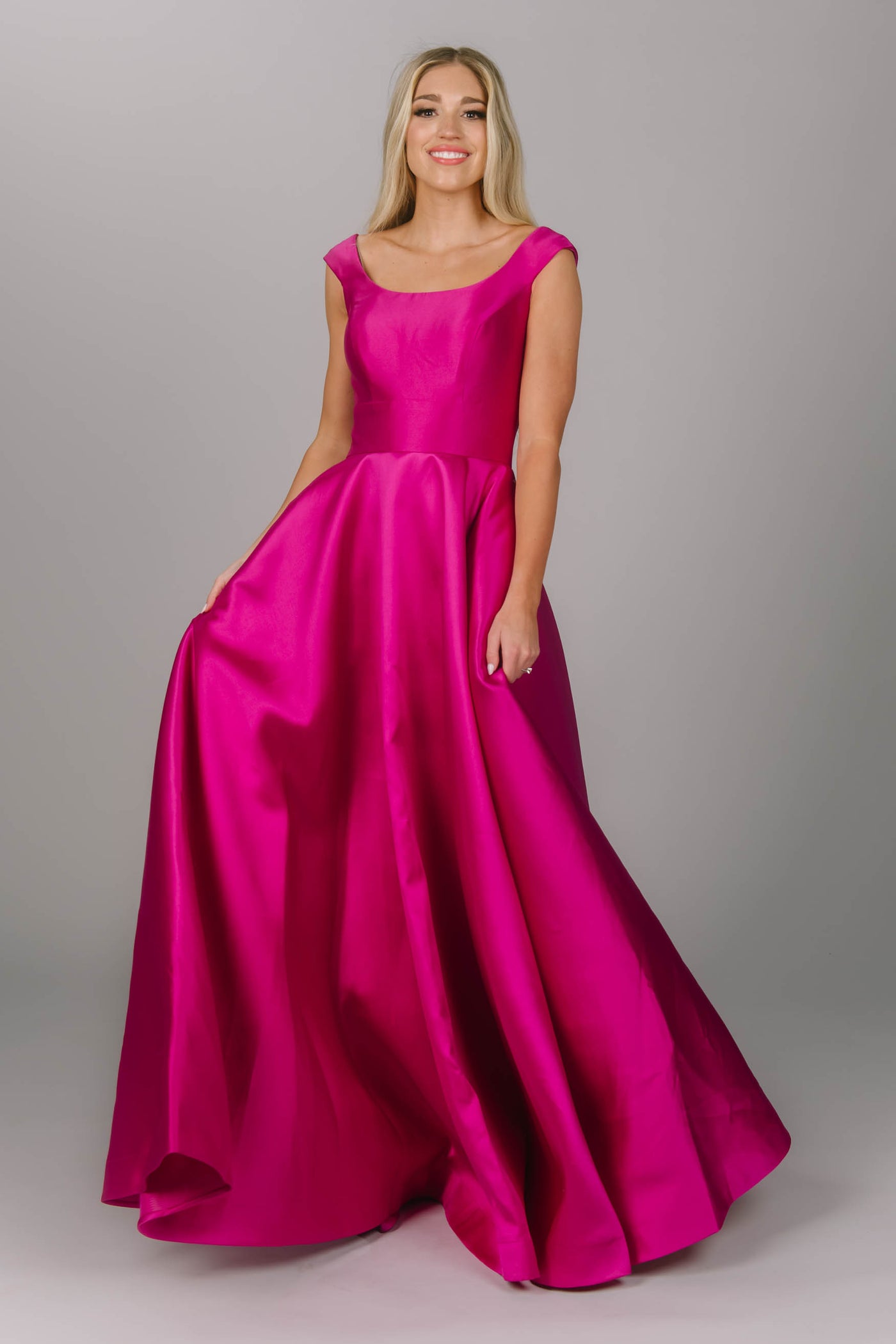 Pink modest prom dress that has a scoop neckline and a-line skirt. It has pockets and is perfect for the modest prom girl.  