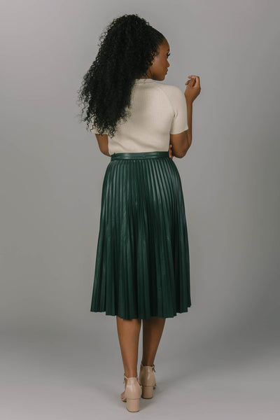 Back view of forest modest skirt. It is pleated and is mid-calf length. This modest skirt is a great addition to your modest collection.