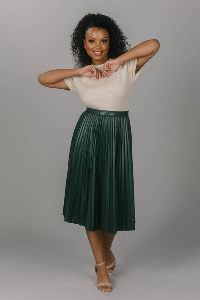 Front view of forest modest skirt. It is pleated and is mid-calf length. This modest skirt is a great addition to your modest collection. 
